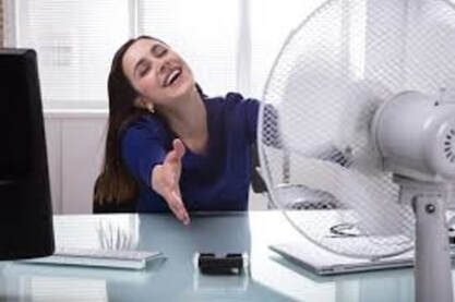 woman with fan needing furnace repair 